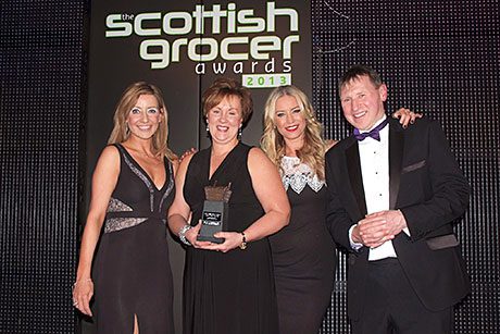 Lee Schofield, Imperial Tobacco’s regional sales manager for Scotland, left, and Denise Van Outen, second right, present the Scottish Grocer Tobacco Retailer of the Year award to Broadway Convenience Store. 