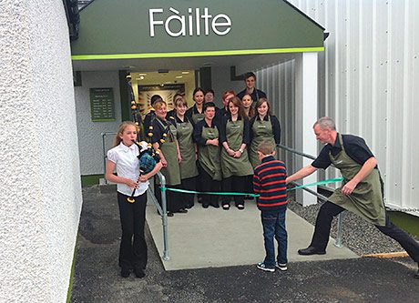 Ronald Maclennan, right, helps some very important people cut the ribbon at Maclennan’s Supermarket on Benbecula.