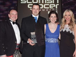 Awards profile – Merchandising award 2013 Wendy Morrell, second right, and her husband Malcolm, second left, receive the 2013 Merchandising Award, run in association with P&G, at the 2013 Scottish Grocer Awards presentation event.