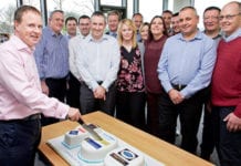 Colin McLean, chief operating officer of Scotmid Co-operative cuts the 100th bakery cake watched by Stephen Brown, bakery and local sourcing manager, second left and operations, support and regional business managers.