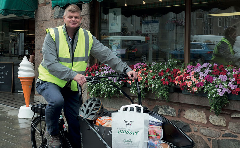 Keith Whyte of Mitchellsa in Inverurie sets out to make a delivery by bike.