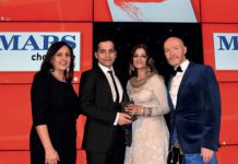 Bep Dhaliwal, trade communications manager, Mars Chocolate UK, left, and awards event host Craig Hill, right, present the Community Champion Award to Asif Akhtar and Abada Akhtar of Smeaton Stores, Kirkcaldy.