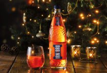 Irn Bru in front of a Christmas tree