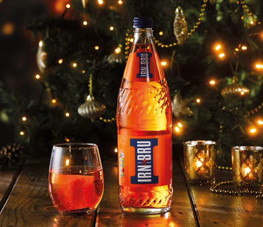 A season with some sparkle Irn Bru in front of a Christmas tree