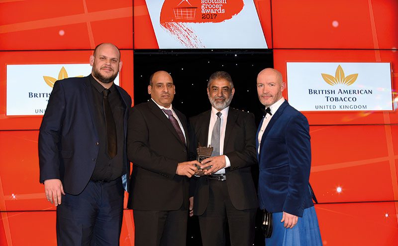 Adam Cann, regional manager north, British American Tobacco UK, left, and awards host Craig Hill, right, present the Tobacco Retailer of the Year Award to Israr Ahmed and Mohammed Sarwar, Pricekracker Dundee.