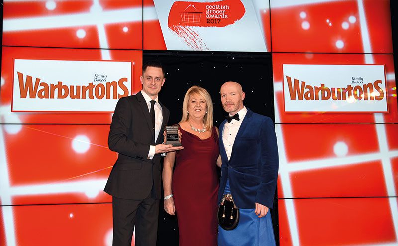 Angie Turnbull, Warburtons retail development area manager, centre, and host Craig Hill, right, present the Scottish Grocer Bakery Retailer of the Year Award (managed store) to Craig McAulay of Scotmid Stockbridge.