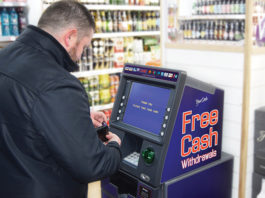 ATMs bring in business Man at cashpoint