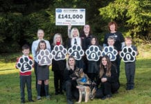 Lexi the dog and Scotmid staff, children, and the SSPCA.