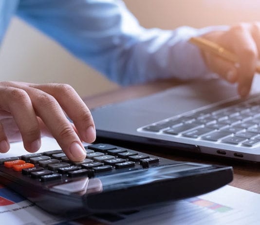 Digital tax date is almost here Person doing sums on a calculator