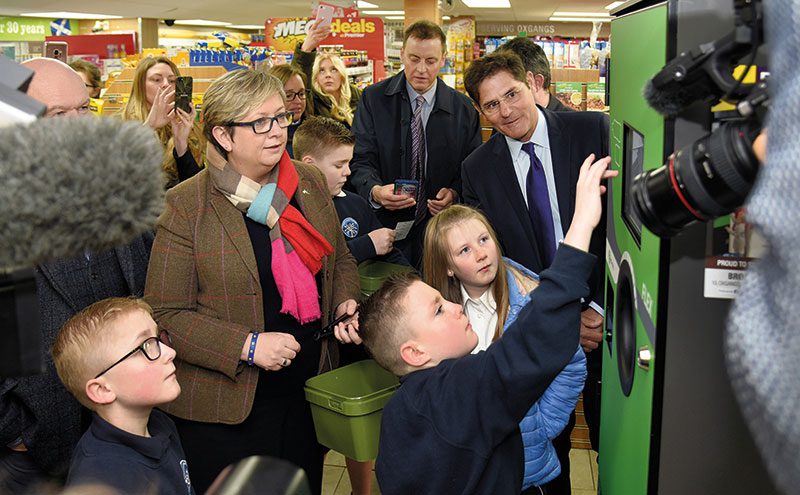 Envipco president Bob Lincoln (right) and Edinburgh South West MP Joanna Cherry watch school kids at the launch of the RVM trial