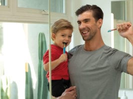 Phelps and Colgate on a water saving crusade dad-and-son-brushing-teeth