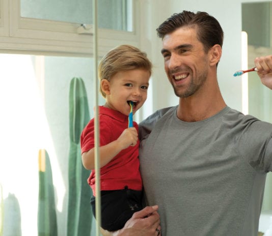Phelps and Colgate on a water saving crusade dad-and-son-brushing-teeth
