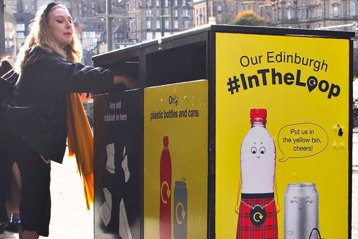 girl putting plastic bottle in recycling bin