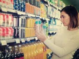 Soft set for a big year Woman looking at soft drinks