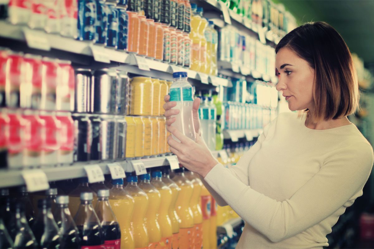 Woman looking at soft drinks