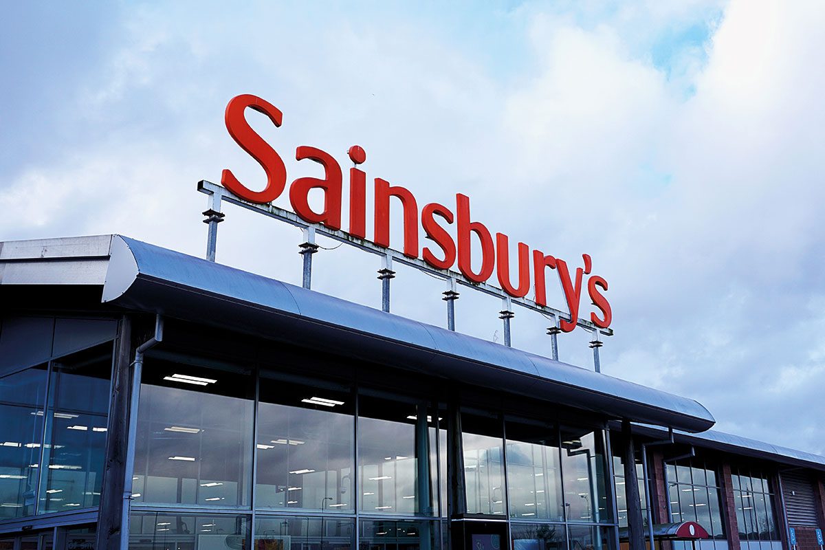 Orange Sainsbury Sign Over Supermarket