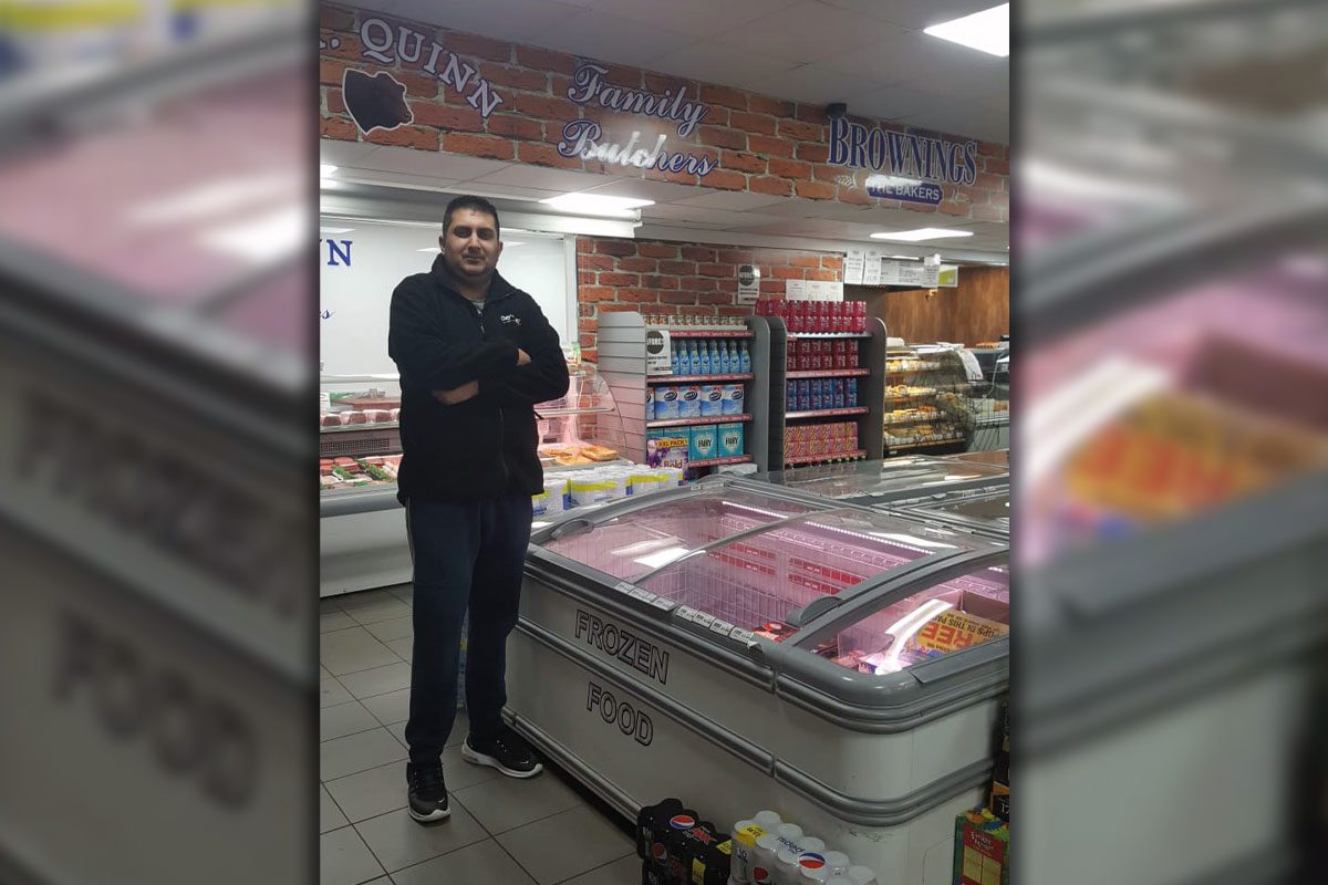 Shopkeeper infront of Freezers