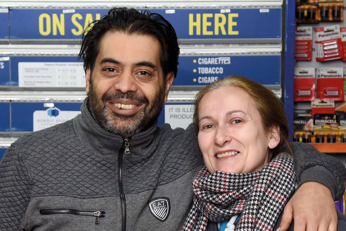 Shop Owners Behind Counter