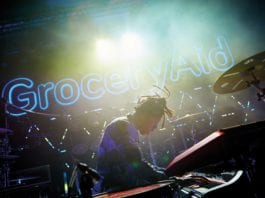 Record event for GroceryAid pianist infront of groceryaid sign