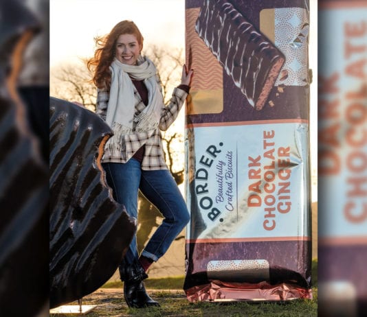 New format for fiery treat woman standing next to border biscuit ad