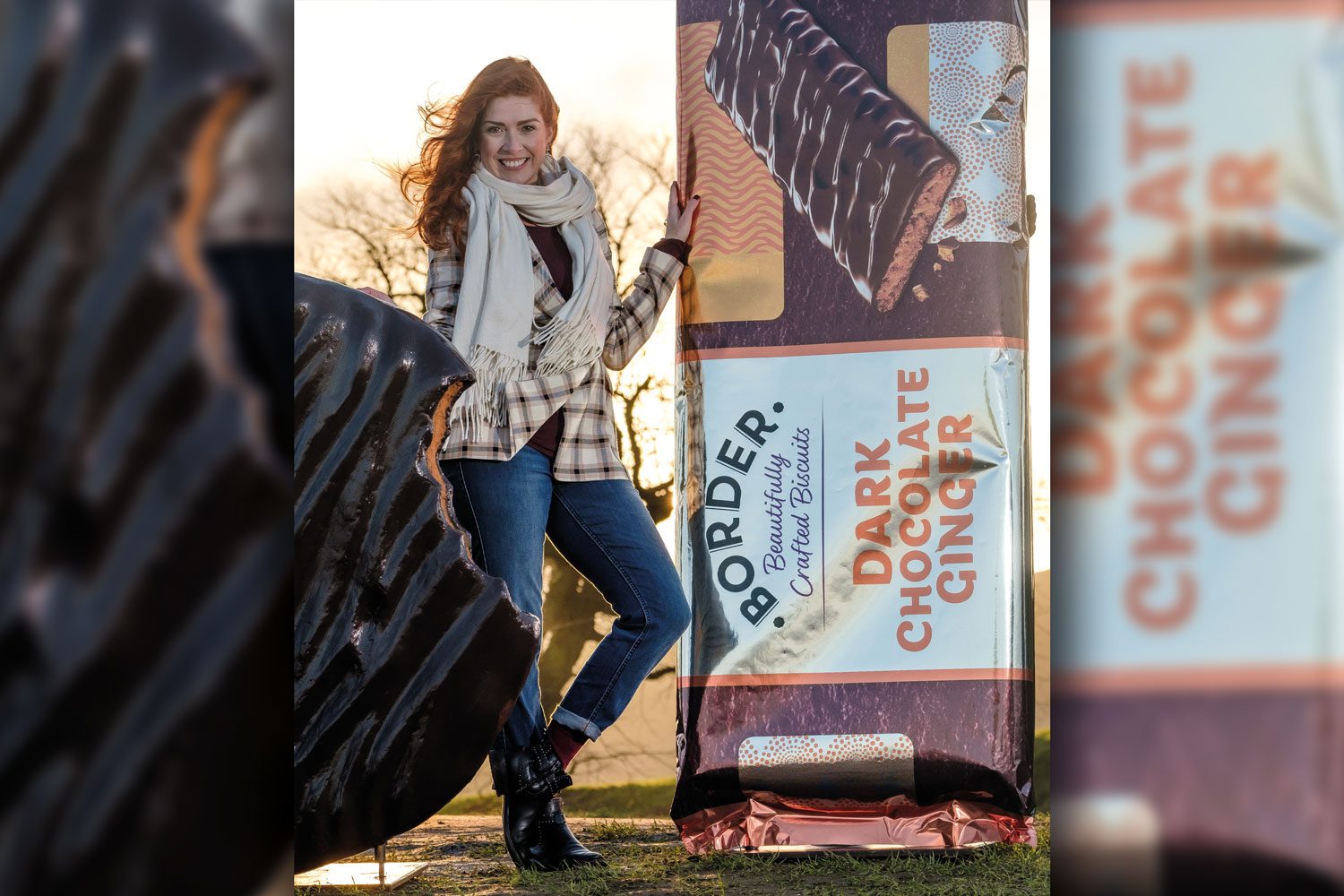 woman standing next to giant border biscuit 