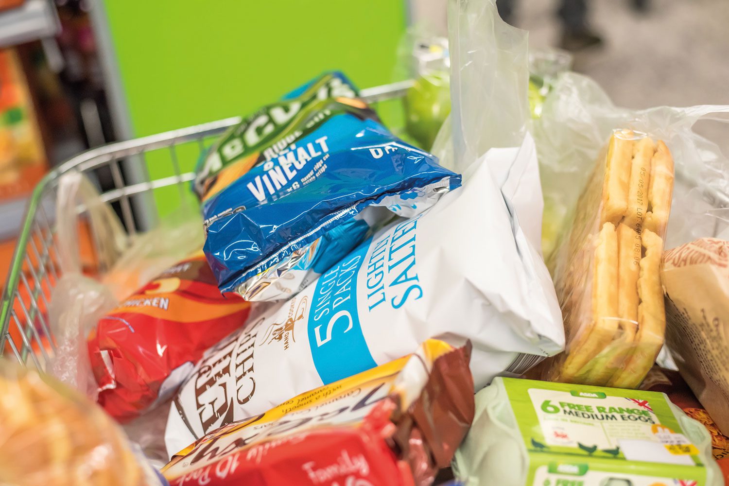 Bags in trolley, green bg