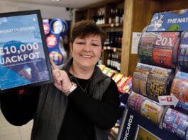 Retailer rewards go digital Camelot-Yvonne-holding-winner-certificate