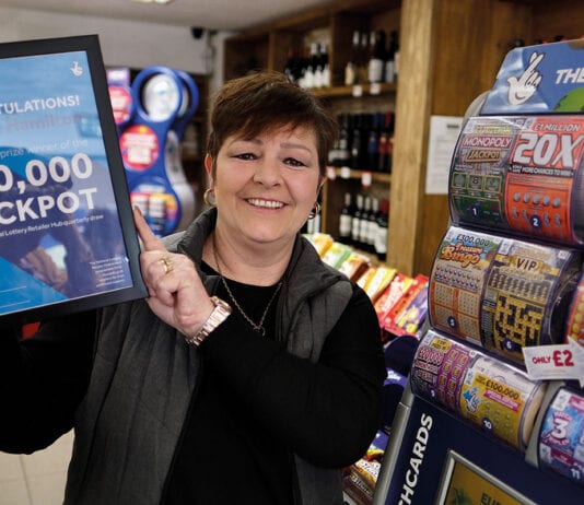 Retailer rewards go digital Camelot-Yvonne-holding-winner-certificate
