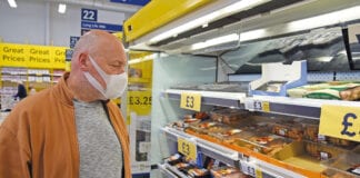 man with mask in shop