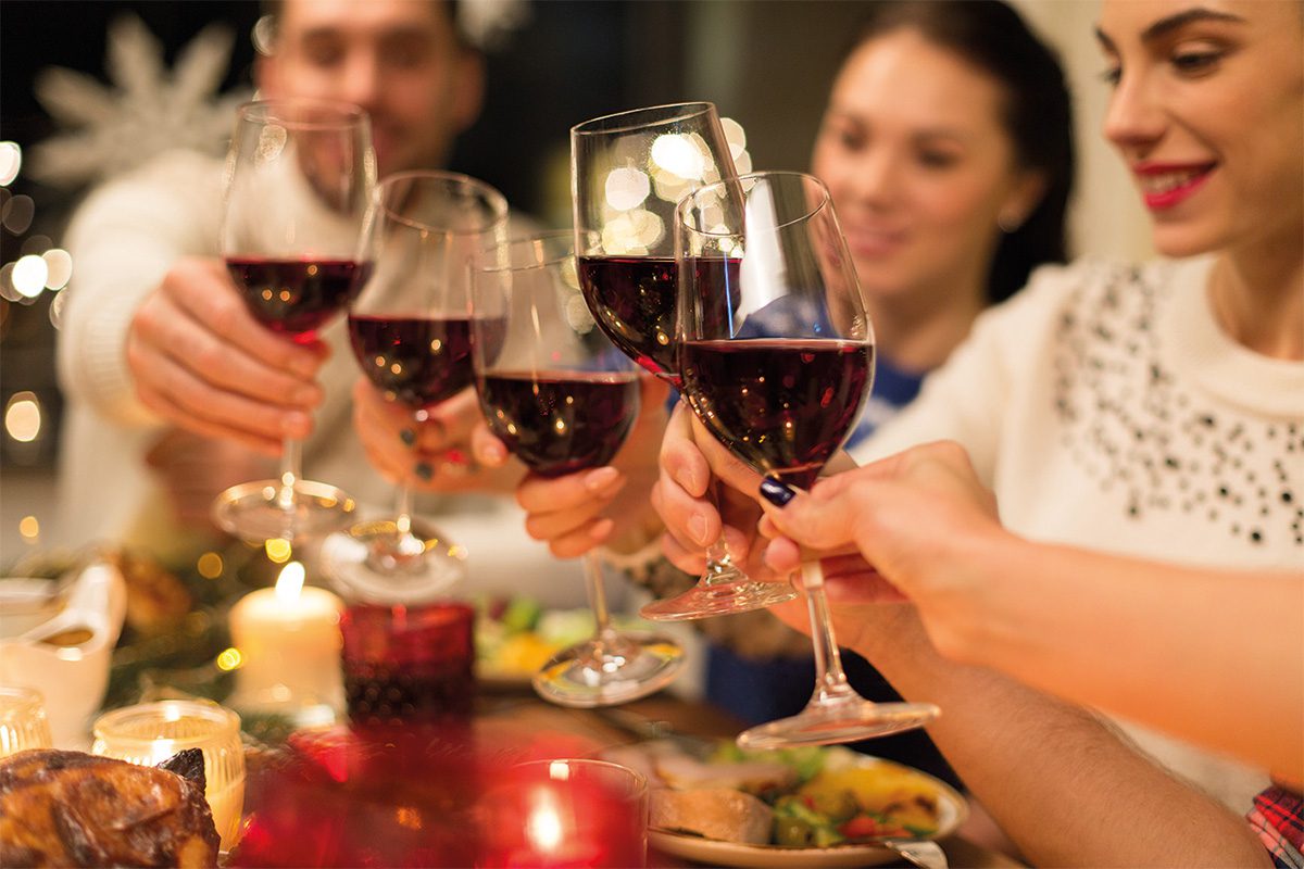 Friends drinking wine at gathering