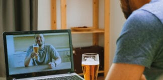 Man on video call drinking a pint