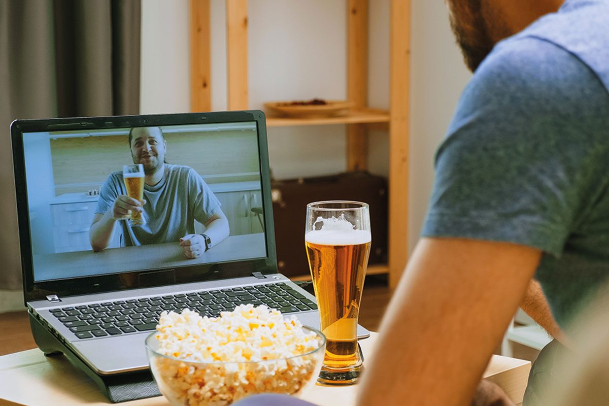 Man on video call drinking a pint 