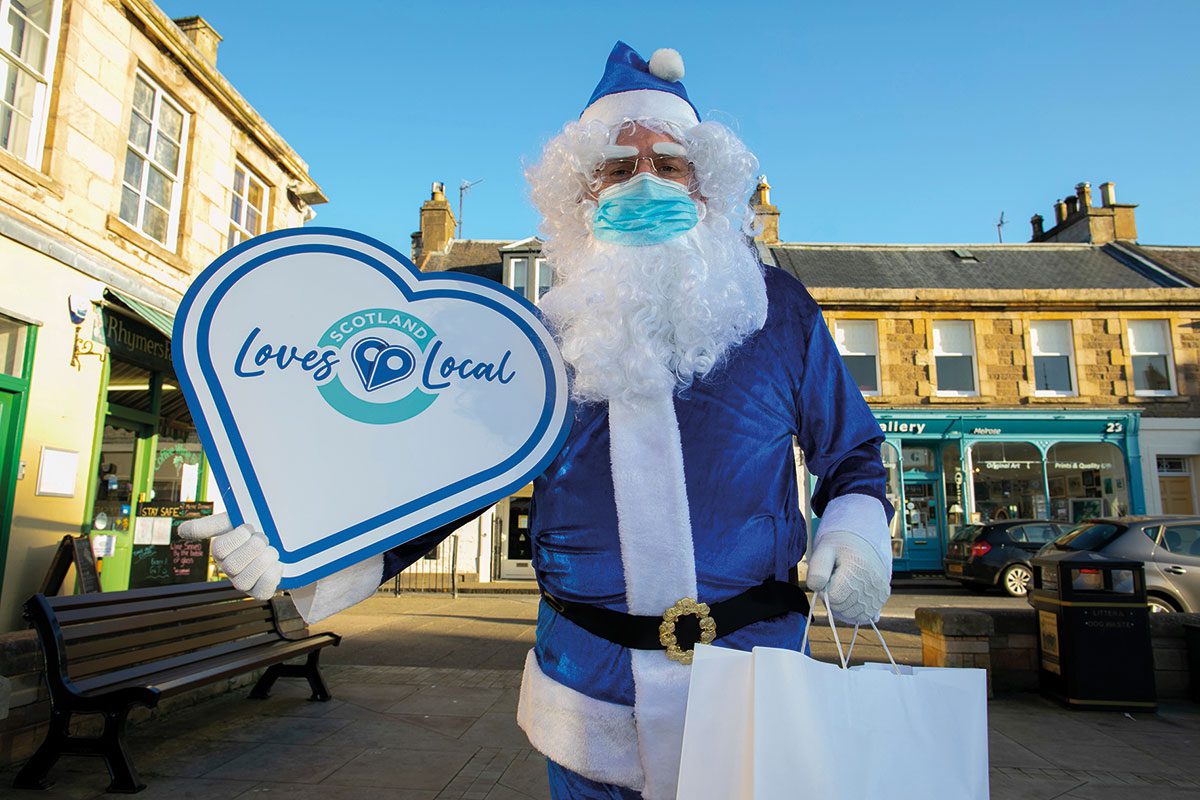 Blue santa with Scotland Loves Local sign 