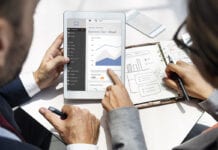 Woman and man looking at a graph on an tablet computer