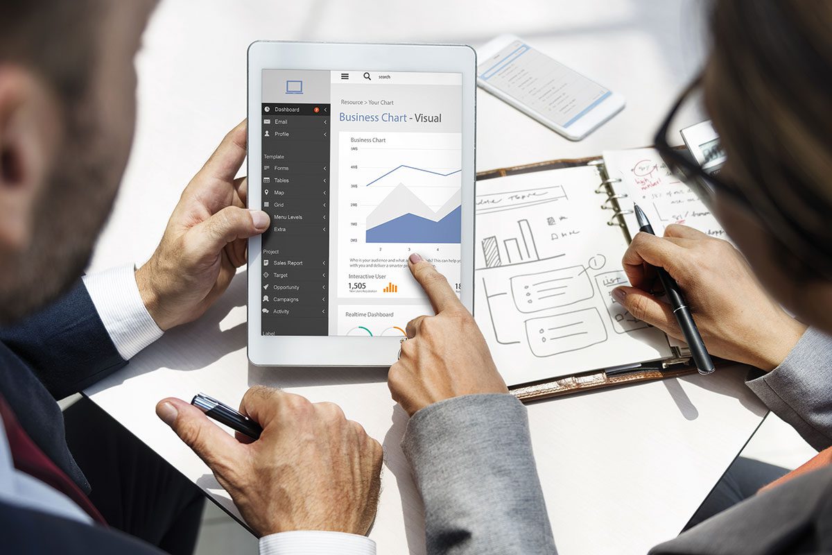 Woman and man looking at a graph on an tablet computer