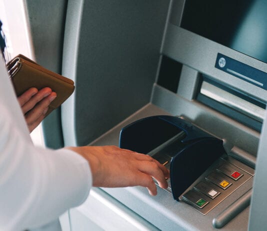 ATMs down, but not out Person at ATM