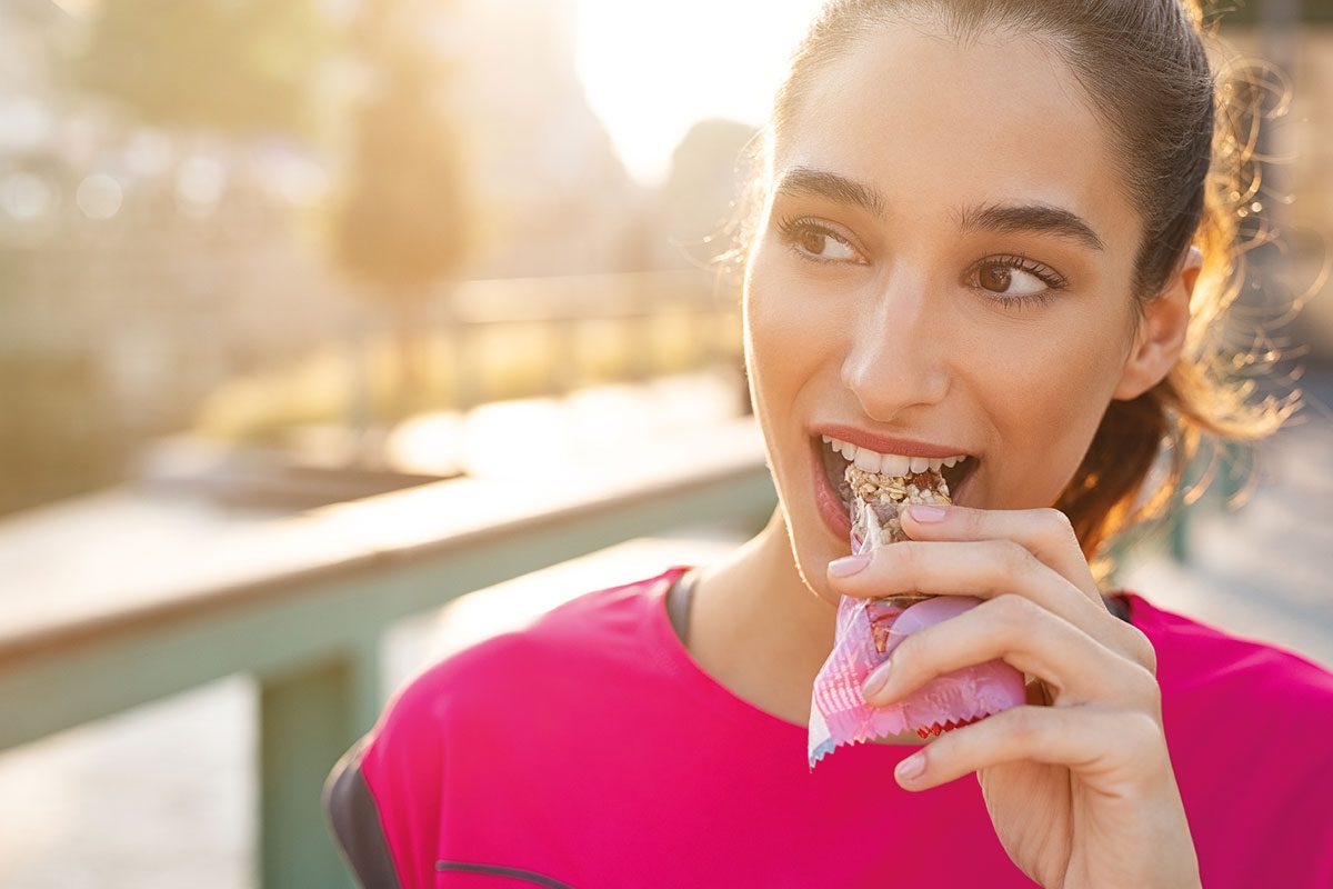 Woman eating granola bar