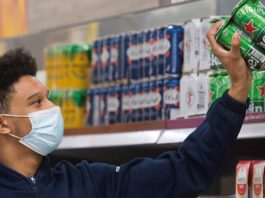 Tesco bans all plastic ring packs Tesco staff stacking shelves
