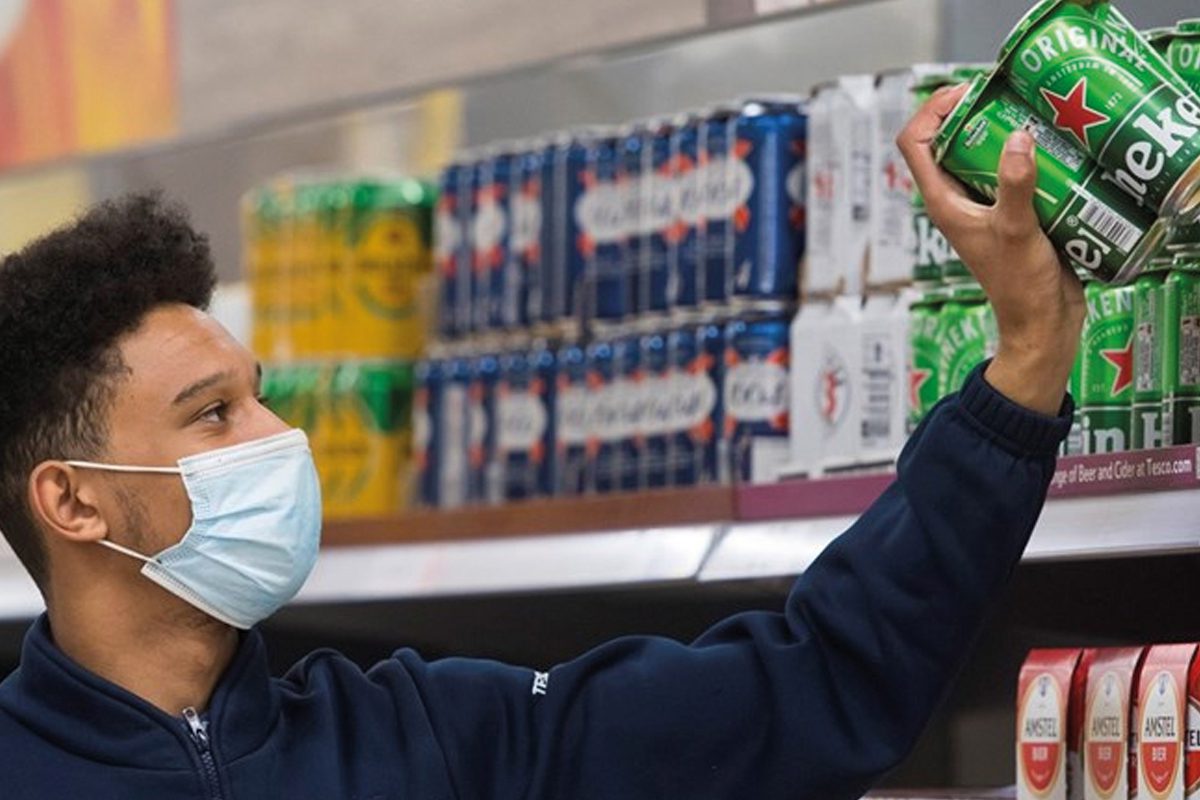 Tesco staff stacking shelves