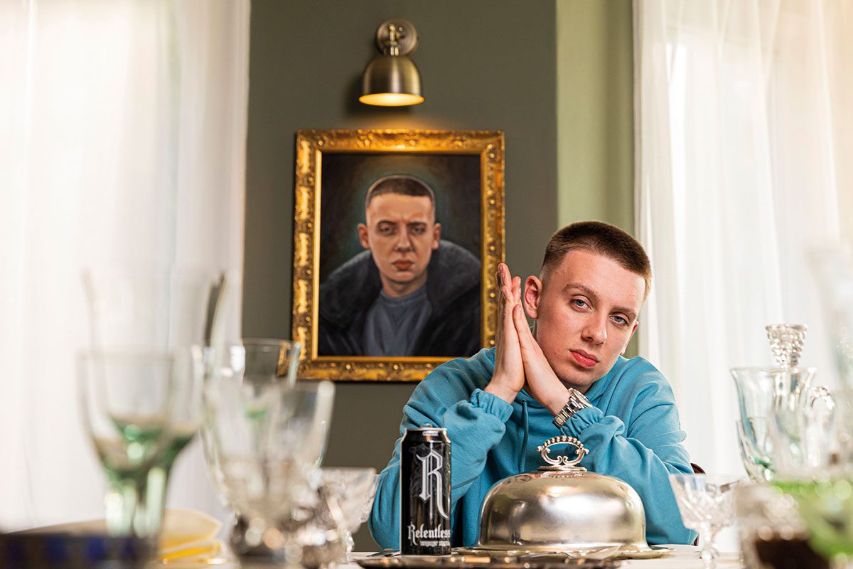 Man posing at dinner table with a can of Relentless