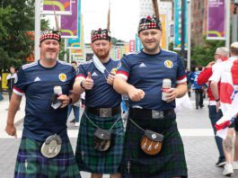 Super score for grocery Men gathered in tartan kilts and Scottish Jerseys