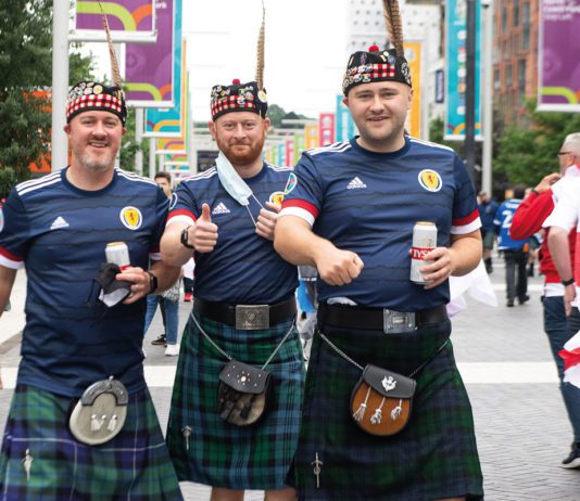 Super score for grocery Men gathered in tartan kilts and Scottish Jerseys