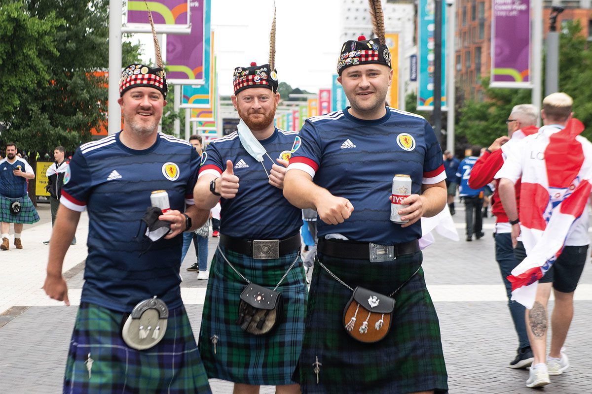 Men gathered in tartan kilts and Scottish Jerseys