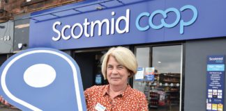 A woman standing outside Scotmid Coop Store Front