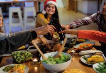 Friends having Christmas dinner with bottles