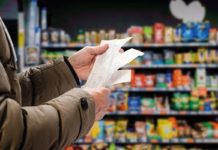 A shopper looks at receipts in a supermarket