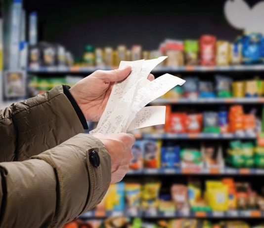 Inflation sustains for January A shopper looks at receipts in a supermarket
