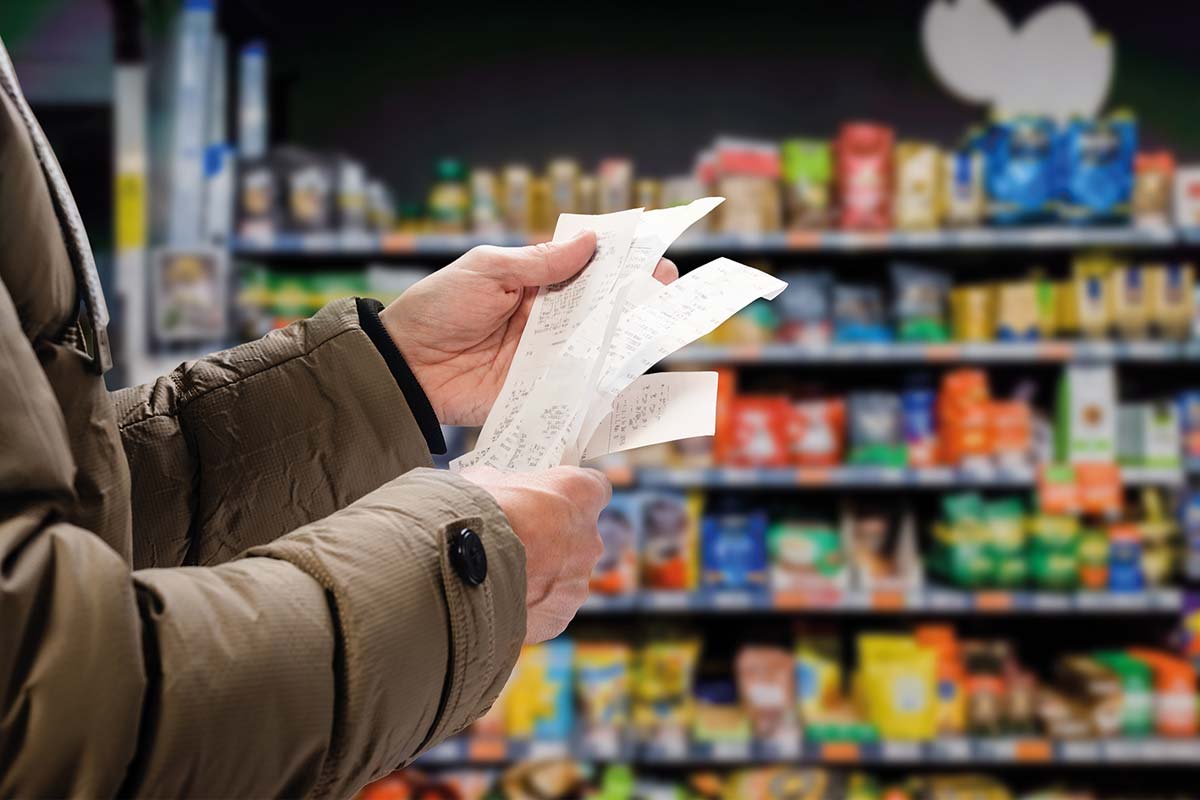 A shopper looks at receipts in a supermarket
