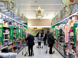 Seasonal sales soar Shoppers in Christmis aisle