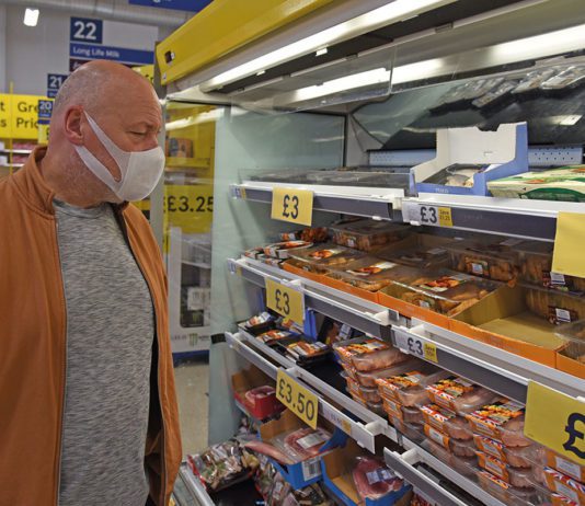 Masks off on 18 April Man wearing mask in supermarket aisle